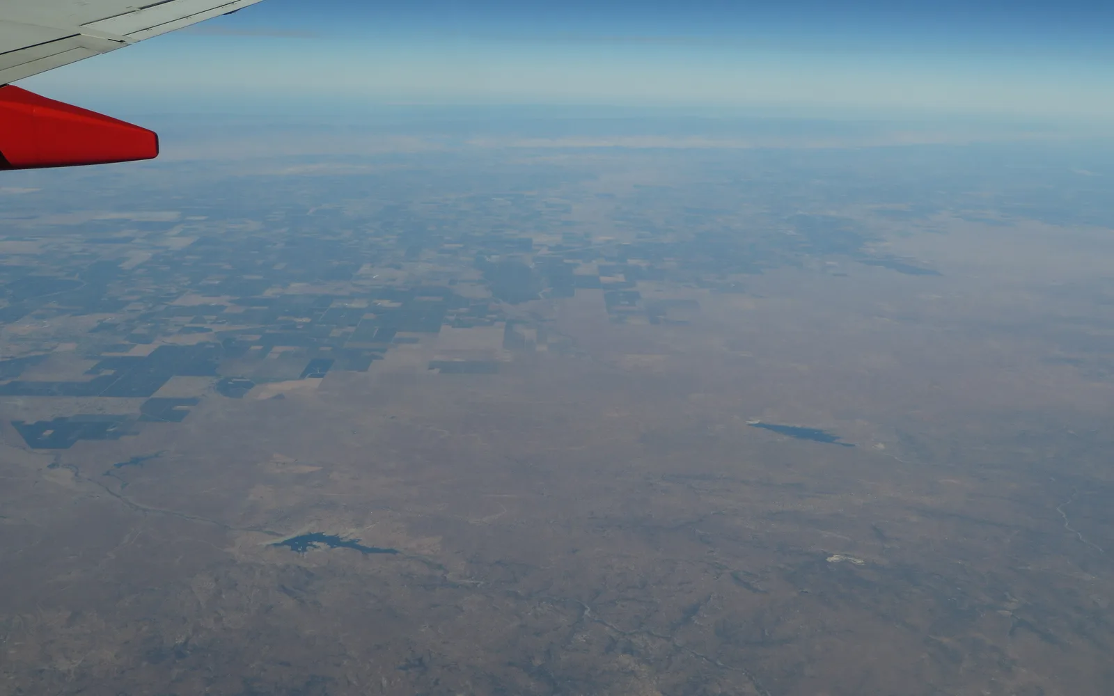 Aerial landscape of California's Central Valley showing agricultural farmland and extensive cultivated fields